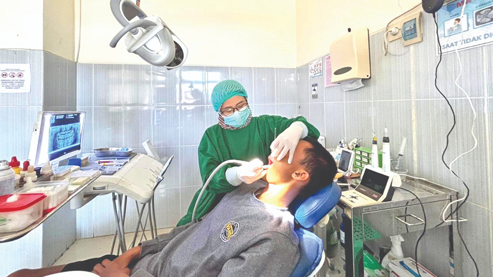 Dokter Gigi Spesialis Konservasi Gigi RSUD Genteng melakukan prosedur perawatan saluran akar gigi pada pasien.