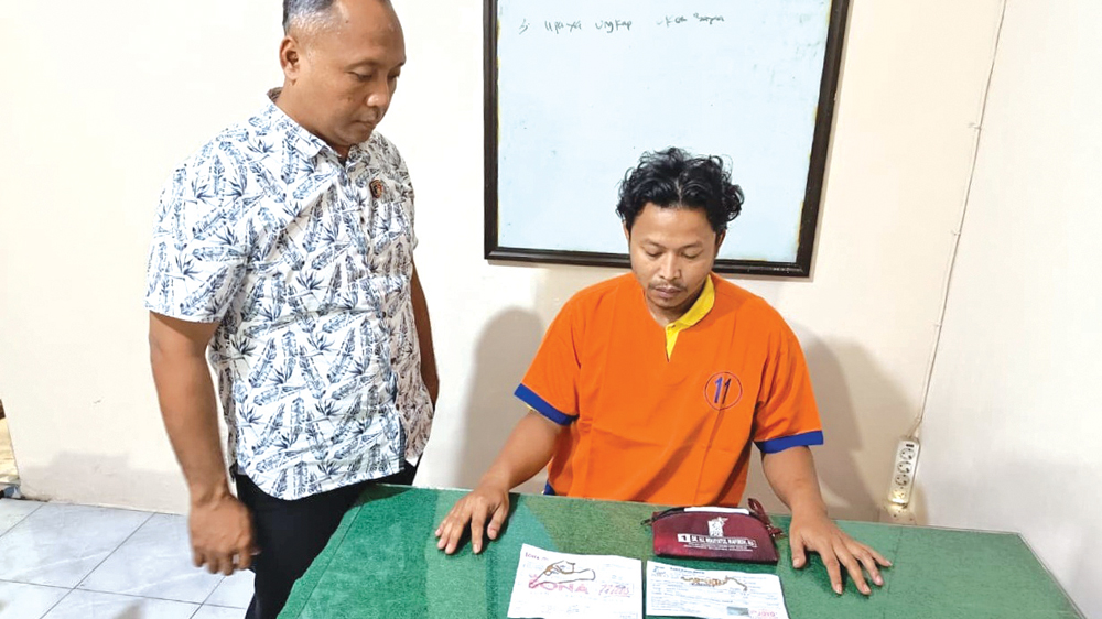 Kanitreskrim Polsek Genteng Ipda Sujarwadi menunjukkan pelaku dan barang bukti kasus pencurian di ruang Unit Reskrim Polsek Genteng pada Sabtu malam (28/2).