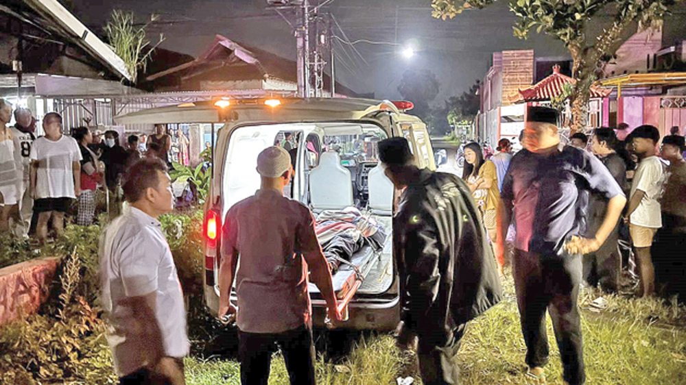 Anggota Polsek Gambiran bersama tim medis Puskesmas Jajag mengevakuasi jenazah pria asal Purwoharjo yang ditemukan meninggal dunia di depan ruko Desa Jajag, Gambiran, Kamis malam (5/3).
