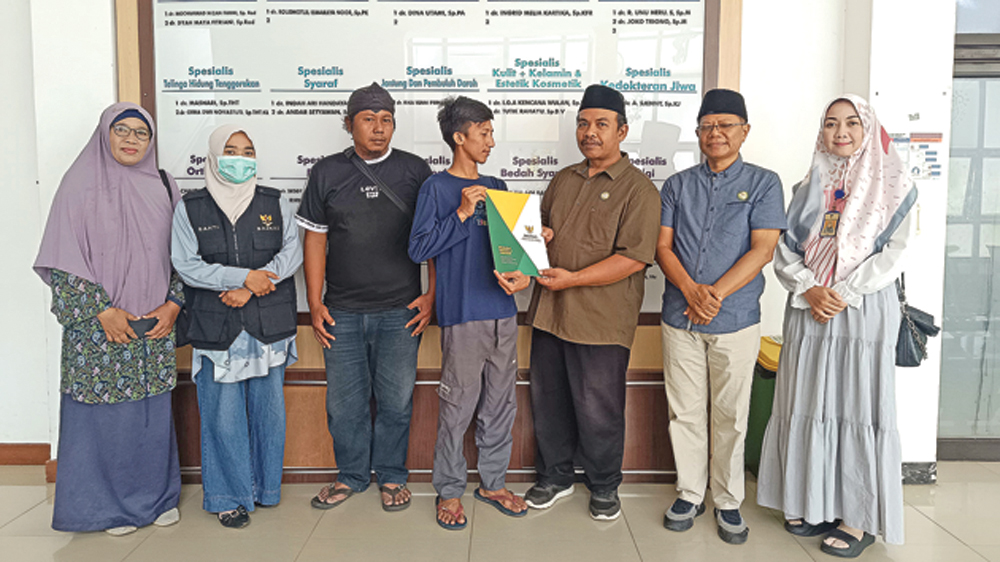 Komisioner Baznas Banyuwangi Nanang Khairurozik dan Dwi Yanto dan perwakilan UPZ Kecamatan Banyuwangi menyerahkan bantuan biaya pengobatan kepada Roimartin di RSUD Blambangan, Sabtu (14/3).