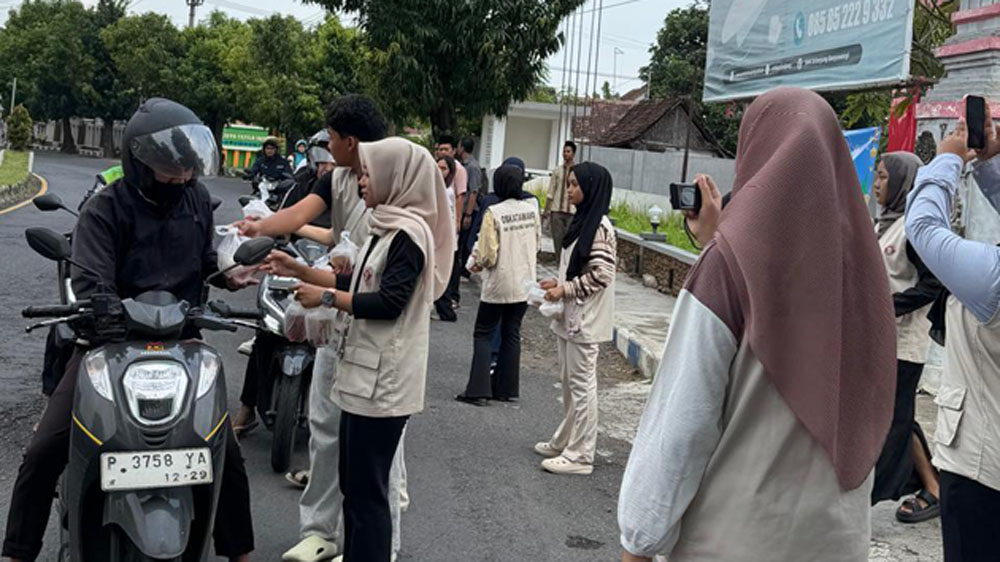 KEPEDULIAN SOSIAL: Siswa-siswi SMK Sritanjung membagikan takjil gratis di depan sekolah mereka di Jalan Brawijaya Banyuwangi, Senin (16/3).