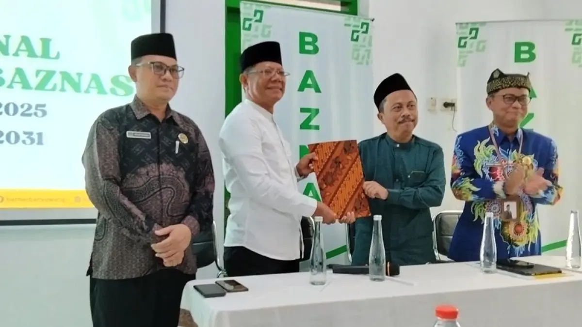PISAH KENAL: Ketua Baznas Kabupaten Banyuwangi periode tahun 2026-2031 Dwi Yanto menerima  berkas laporan keuangan dari Ketua Komisioner periode Tahun 2020-2025 Lukman Hakim di Kantor Baznas Jalan Ahmad Yani Banyuwangi pada Rabu (8/4). (Irwan Baznas fo Radar Banyuwangi)