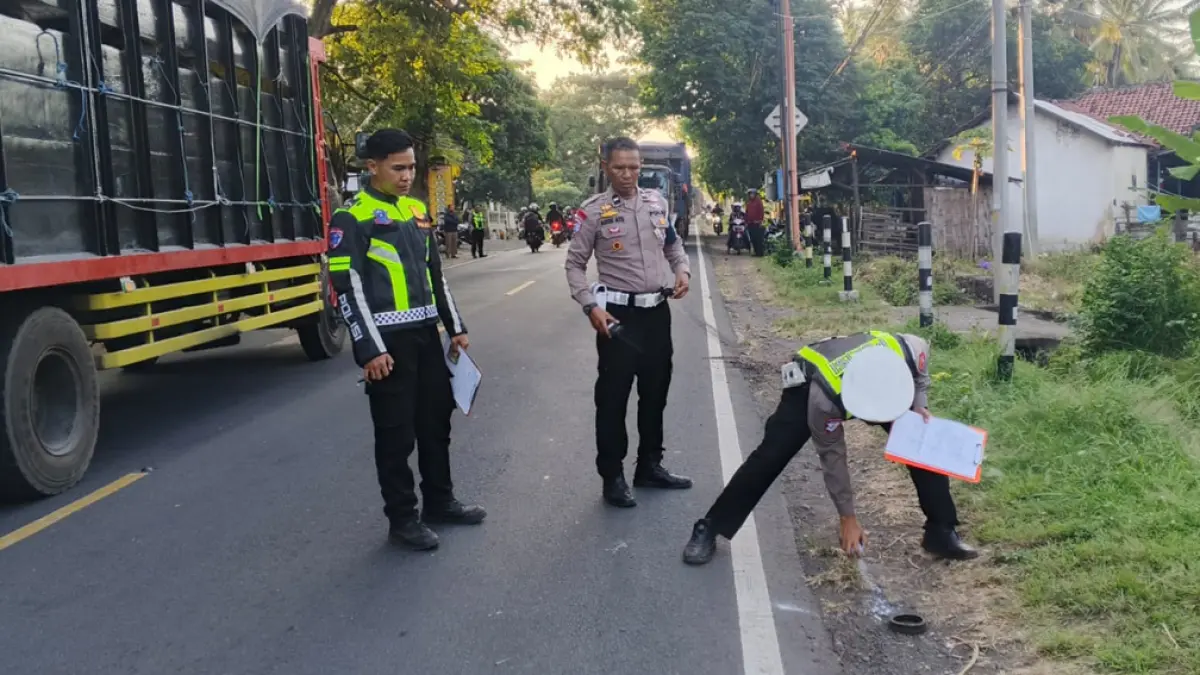 TELAN KORBAN: Personel Satlantas melakukan olah TKP kecelakaan yang menewaskan dua orang di depan Toko Listrik Al-Barokah, Desa Bangsring, Kecamatan Wongsorejo, Jumat (17/4). (Polres Wongsorejo)