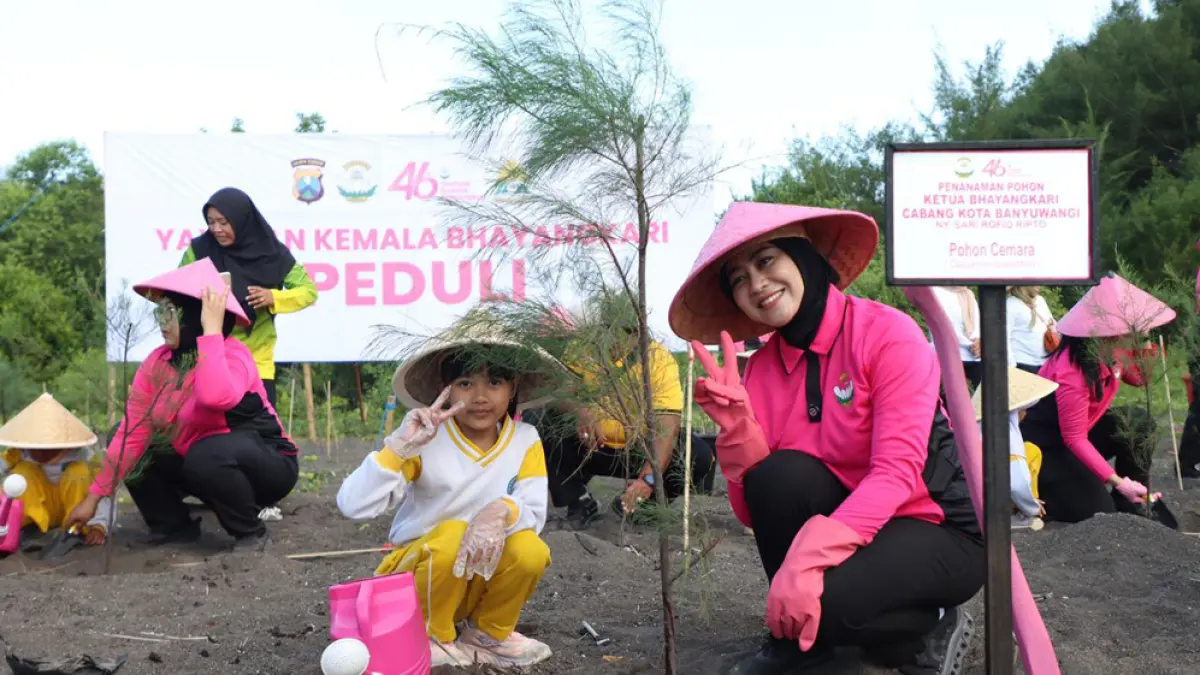 PENGHIJAUAN: Ketua Bhayangkari Cabang Kota Banyuwangi sekaligus Ketua Pengurus Yayasan Kemala Bhayangkari Cabang Kota Banyuwangi adalah Ny Sari Rofiq Ripto mengajak anak TK menanam pohon cemara di Pantai Cemara, Kelurahan Pakis, Kamis (23/4). (Humas Polresta Banyuwangi)