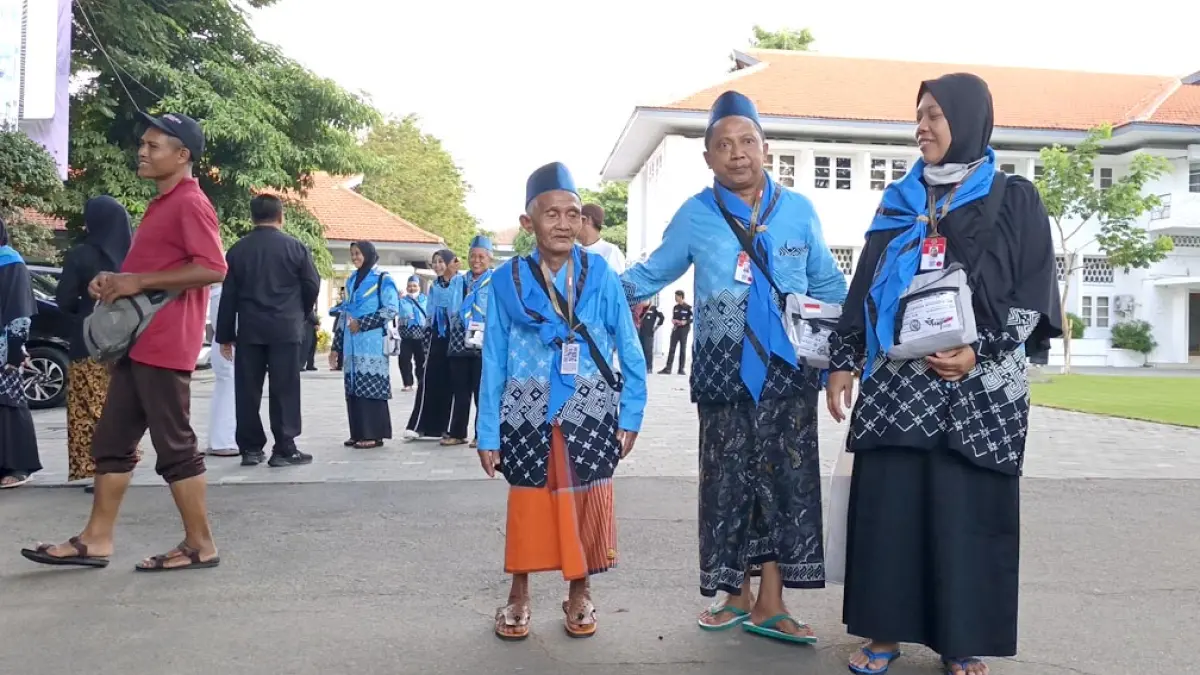 JEMAAH TERTUA: Ropingi (kiri), CJH asal Dusun Panjen 4 RT 3 RW 3, Desa Jambewangi, Kecamatan Sempu bersiap berangkat di kantor Pemkab Banyuwangi. (M Ksatria/Radar Banyuwangi)