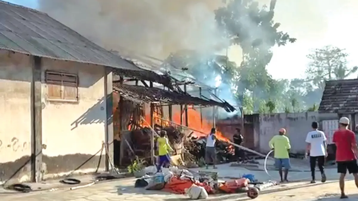MEMBARA: Petugas Damkarmat dibantu warga berusaha memadamkan api yang membakar gudang kayu di Desa Sidorejo, Kecamatan Purwoharjo, Minggu sore (7/6). (Irfan for Radar Banyuwangi)
