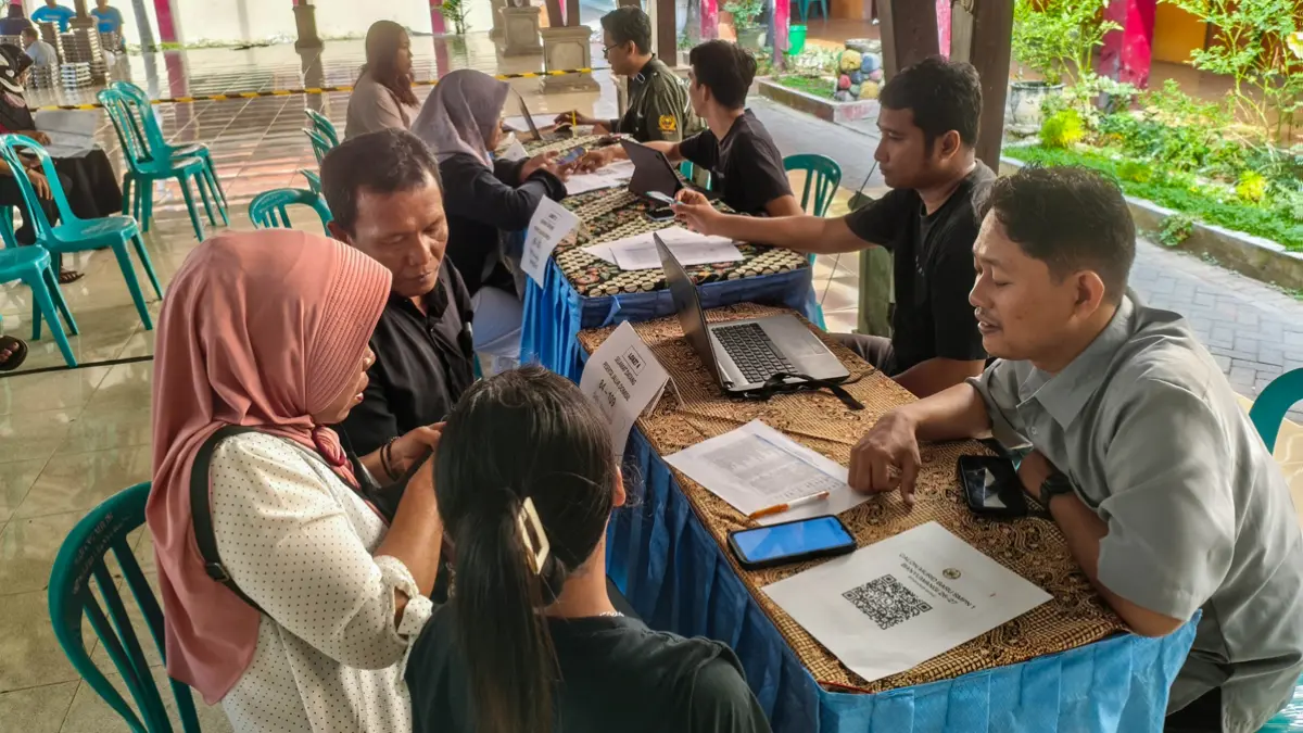 BERI ARAHAN: Calon siswa didampingi orang tua mendatangi helpdesk SPMB di SMPN 1 Banyuwangi, Jumat (12/6). (Ramada Kusuma/Radar Banyuwangi)