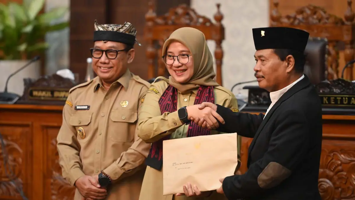 Bupati Banyuwangi Ipuk Fiestiandani didampingi Wabup Mujiono menyerahkan berkas jawaban eksekutif terhadap PU fraksi dalam rapat paripurna di kantor DPRD Banyuwangi, Senin (15/6). (Ramada Kusuma/Radar Banyuwangi)