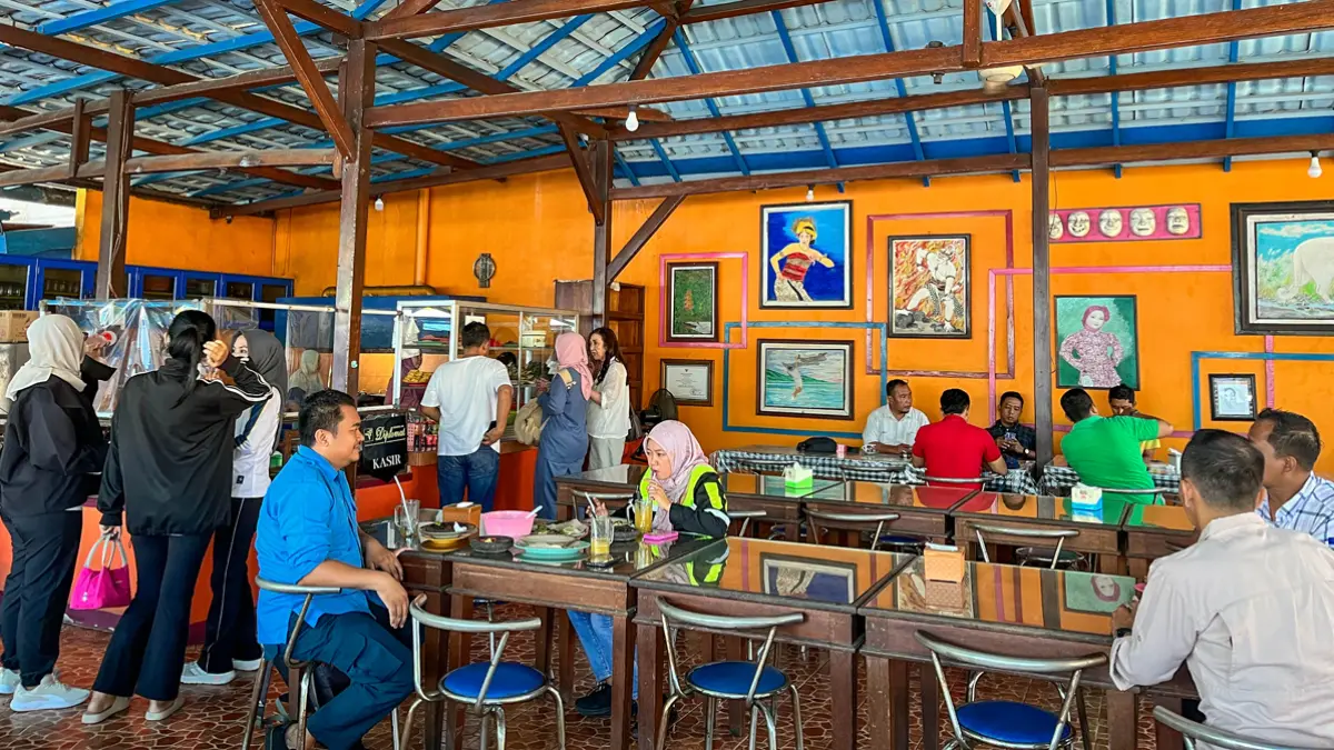 RAMAI PEMBELI: Pelanggan Pondok Boga menikmati makan siang dengan sajian aneka menu lalapan. Warung ini dirintis sejak tahun 1996. (Ramada Kusuma/Radar Banyuwangi)