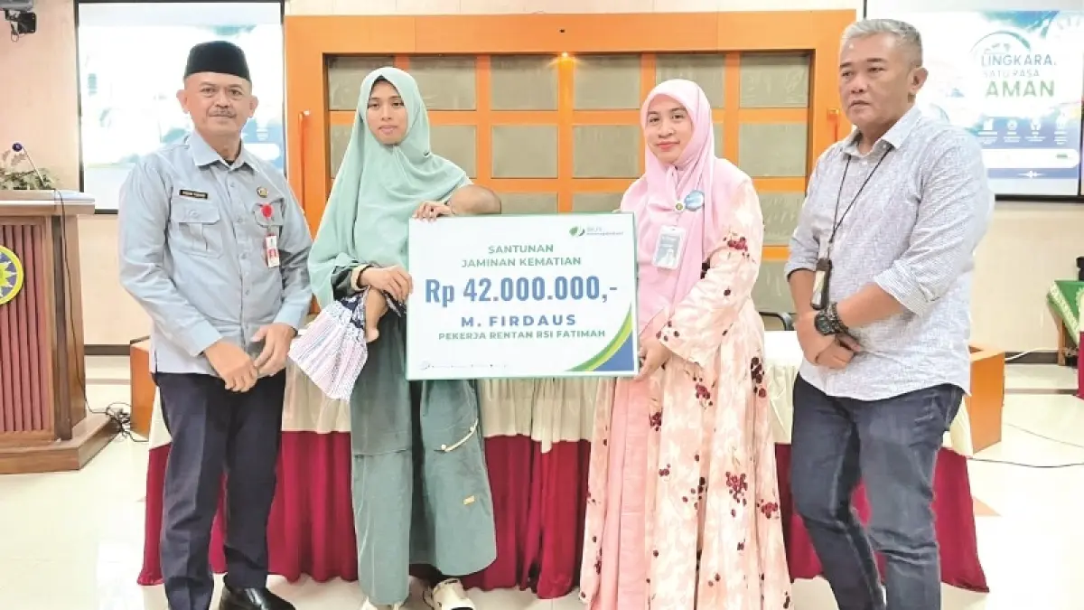 SIMBOLIS: Direktur RSI Fatimah Banyuwangi dr Widowati bersama Kepala Disnakertransperin dan Kepala Cabang BPJS Ketenagaan Banyuwangi menyerahkan santunan kepada ahli waris salah satu peserta Program GN Lingkaran.(RSI Fatimah Untuk Raba)