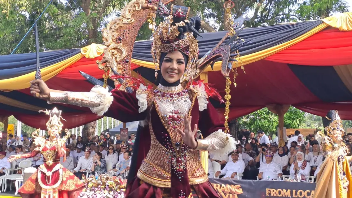 Puteri Indonesia Aceh 2025 Mutiara Hasanah dibuat terpukau oleh kemegahan Banyuwangi Ethno Carnival 2026 bertema Perang Bayu. (Meivira untuk Radar Banyuwangi)