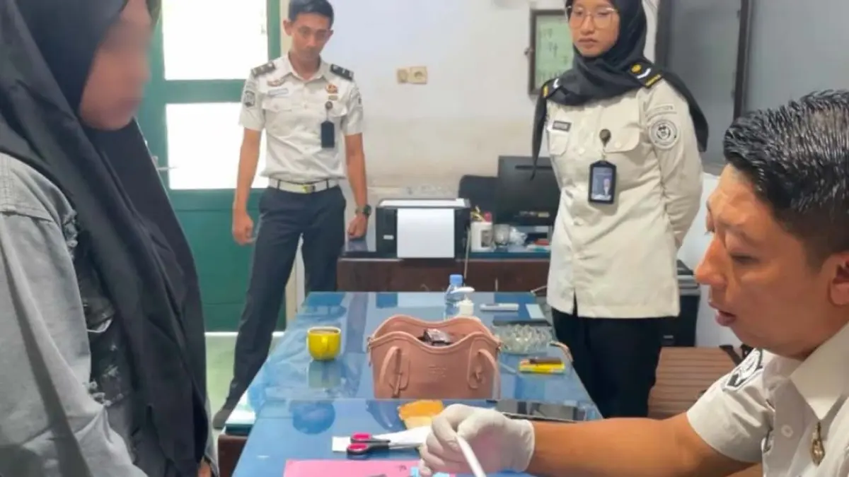 HENDAK BESUK KERABAT:  DAT (kiri) diinterogasi Kalapas Solichin di ruangan Lapas Banyuwangi, Kamis sore (13/8). (Foto: Lapas Banyuwangi)