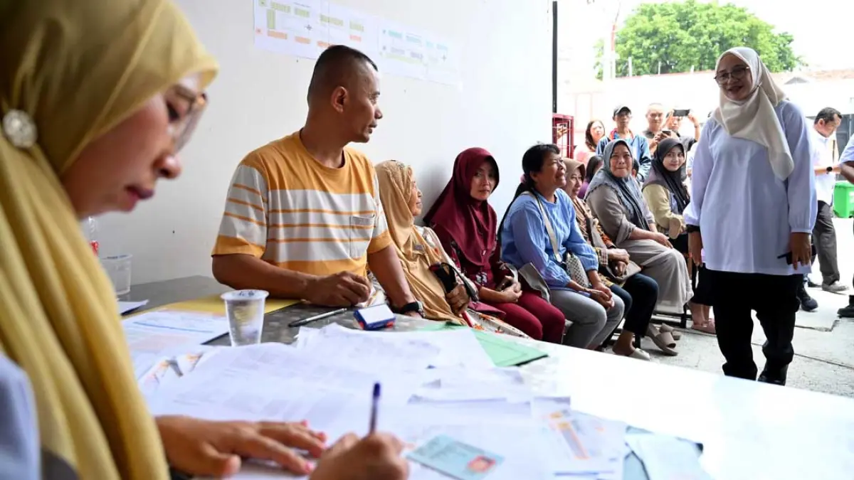 Bupati Ipuk Fiestiandani (kanan) menyapa dan berdialog langsung dengan para pedagang yang sedang mengantre di Posko Pengaduan Pasar Induk Banyuwangi, Rabu (23/9). (Ramada Kusuma/Radar Banyuwangi)