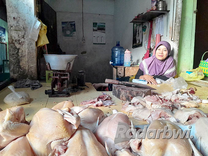 BERTUMPUK: Salah satu pedagang ayam potong Nuryati menunggu pembeli di Pasar Kalibaru, Desa Kalibaru Wetan, Kecamatan Kalibaru, Rabu (22/6) lalu. (Irham Muzaki/Radar Genteng)