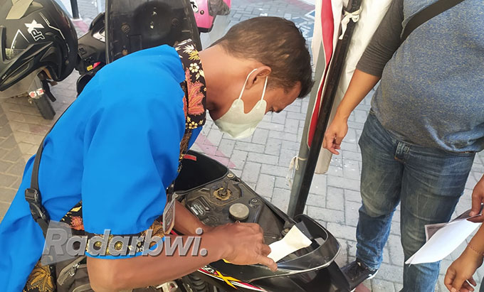 Ilustrasi petugas SAMSAT mencocokkan nomor rangka kendaraan dengan STNK motor milik warga yang hendak membayar pajak. (Dok Radar Situbondo)