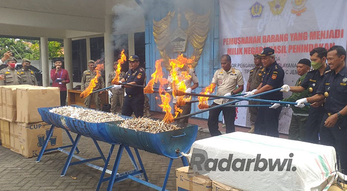 DIBAKAR: Bea dan Cukai Jember bersama Satpol PP Situbondo memusnahkan rokok ilegal di halaman Kantor Bea Cukai di Desa Wringinanom, Kecamatan Panarukan, Jumat (26/8) lalu. (Iwan Feriyanto/Radar Situbondo)