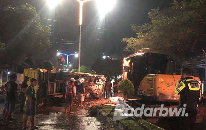 SEMPAT MACETKAN JALAN: Dump truck yang terguling di Jalan Letjen S. Parman, Lingkungan Pakis, Kelurahan Sumberrejo, dievakuasi pada Kamis malam (24/11). (GAKKUM UNTUK RABA)