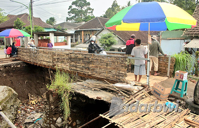 HANYA SEMENTARA: Jembatan darurat yang menghubungkan RW 13 dan RW 05 di Dusun Krajan, Desa Kalibaru Wetan, Kecamatan Kalibaru sudah bisa dilalui roda dua, Senin (14/11). (SALIS ALI/JPRG)