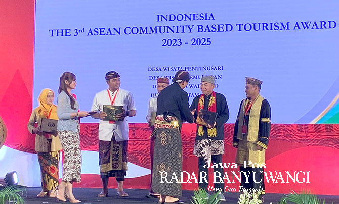 PRESTASI MEMBANGGAKAN: Menparekraf RI Sandiaga Salahuddin Uno menyerahkan penghargaan kepada Ketua Lembaga Desa Wisata Tamansari Mahsun di Jogjakarta, Minggu (5/2). (Disbudpar untuk Radar Banyuwangi)